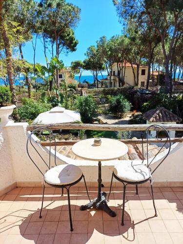 two chairs and a table on a patio at La Villetta Adults Only con giardino a Pula in Pula