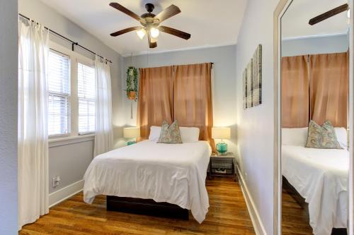 a bedroom with two beds and a ceiling fan at Urban Zen Great Location in Memphis