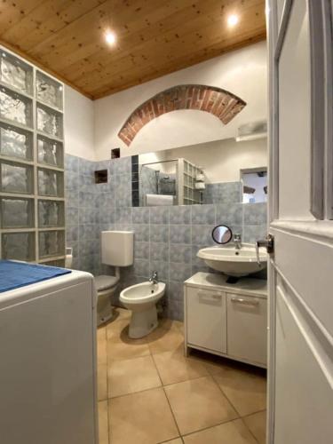a bathroom with a sink and a toilet in it at Appartamento vacanze Loano in Loano