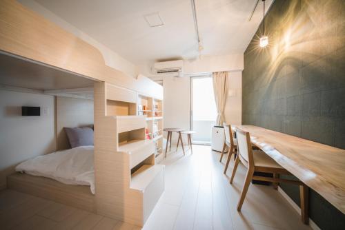 a room with a bed and a desk and a table at Hotel Axas Nihonbashi in Tokyo