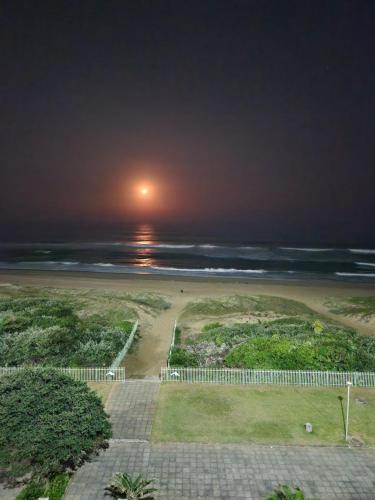 a view of the beach at night at Lescalier 513 Luxury sea facing unit in Amanzimtoti
