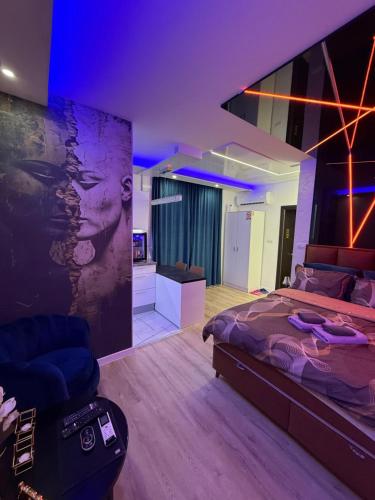 a bedroom with a large bed and a couch at Foča Apartman STORY LUX in Foča