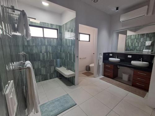 a bathroom with a shower and a sink and a toilet at Blue Wings Villa in Fortuna