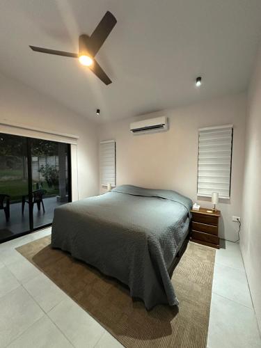 a bedroom with a bed and a ceiling fan at Blue Wings Villa in Fortuna