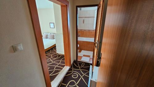 an open door to a room with a bedroom at Penzión Magnólia in Trenčín