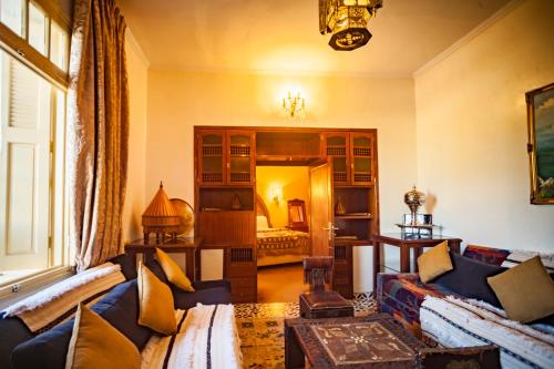 a living room with couches and a room with a bed at Villa Pomme d'Or in Midelt