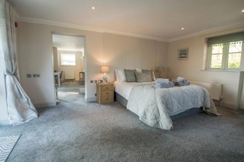 a bedroom with a large bed and a window at The Foxes Den in Assington