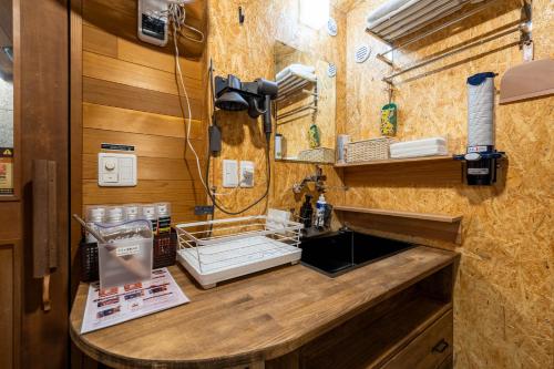 a kitchen with a counter and a sink in a room at SAUNA and VILLA Takibi in Makkari