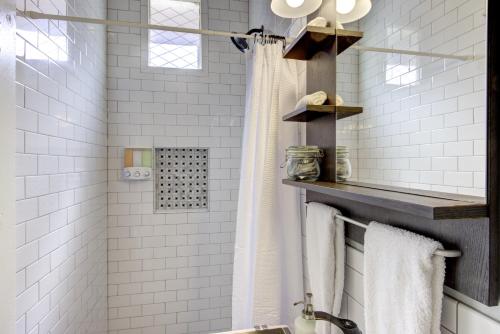 a bathroom with white subway tiles and a shower at Unwind and Relax in a Historic Midtown Property in Memphis