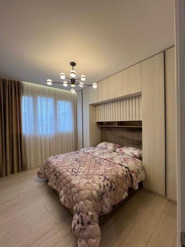 a bedroom with a large bed with a headboard at Fabio Home in Tirana