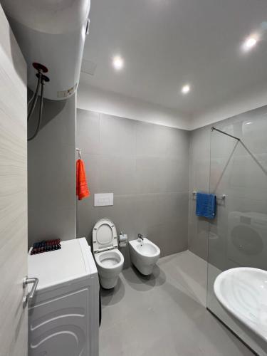 a bathroom with a toilet and a sink at Fabio Home in Tirana