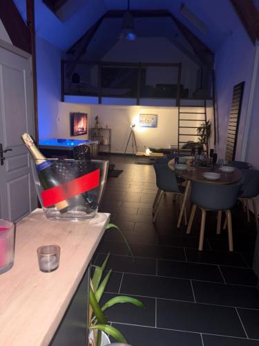 a room with a table with a bottle on a counter at Le Loft in Anzin