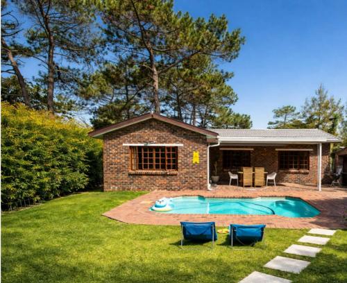 a house with a swimming pool in the yard at 3 Bedroom Family Home, Pool & Garden, Upper Constantia in Constantia