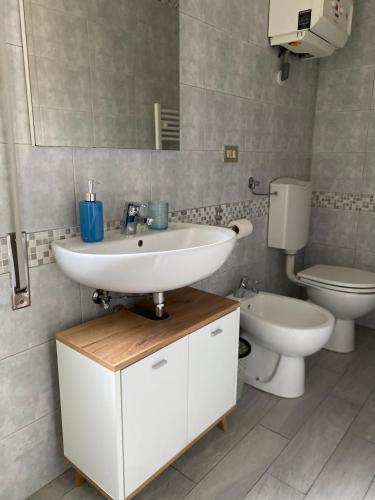 a bathroom with a sink and a toilet at Indy Sea Home in Lido degli Estensi