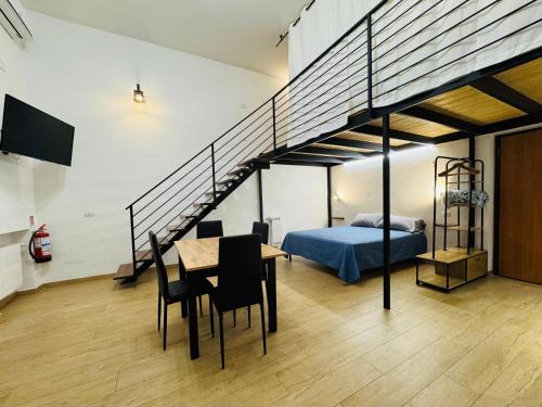 a bedroom with a bed and a table with chairs at Il Pilone in Barletta