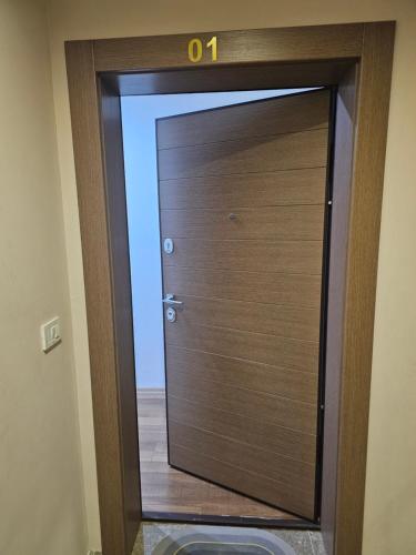 a wooden door with a number on top of it at Dino Saraj in Skopje