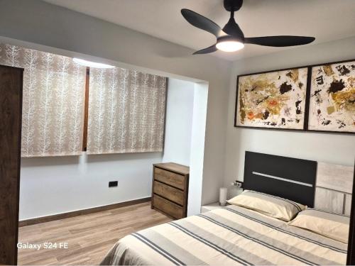 a bedroom with a bed and a ceiling fan at Brisa Marina in Cullera