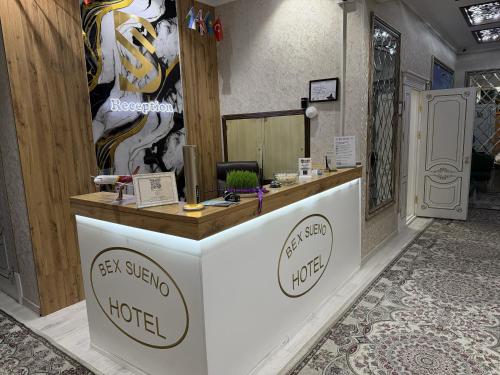 a shop with a reception desk in a room at BEX SUENO HOTEL in Samarkand