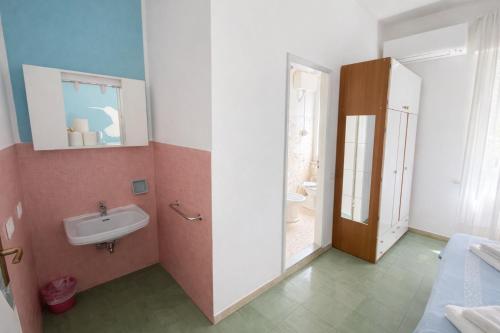 a bathroom with a sink and a toilet in it at Hotel Aloha dipendenza Villa Silvie Rose in Cesenatico
