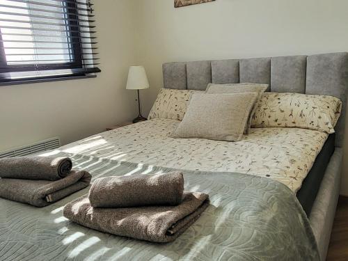 a bedroom with a large bed with pillows on it at Ostoja Orli Dziób B2 in Kal
