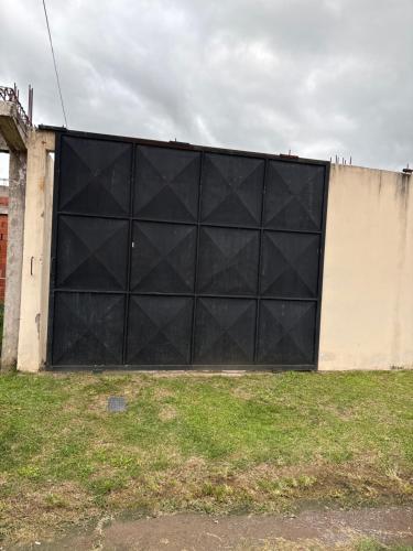 a large black garage door on the side of a building at Paz y Eva in Salta