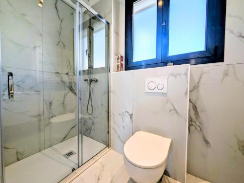 a bathroom with a toilet and a glass shower at La Régalide 2A in Roquebrune-Cap-Martin