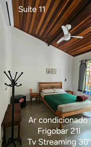 a bedroom with a bed with a wooden ceiling at Hostel Jai Juquehy in Juquei