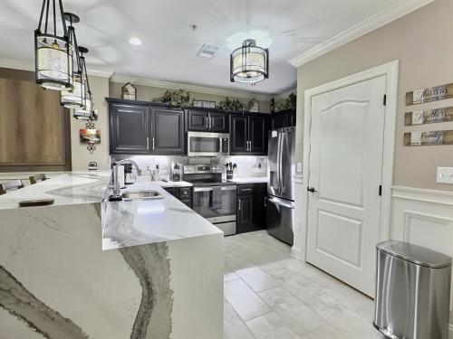 a kitchen with black cabinets and a white counter top at Serenity at the Summit in Gatlinburg