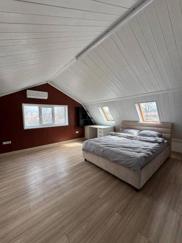 a large bedroom with a bed in a attic at Odessky Dvorik in Chişinău