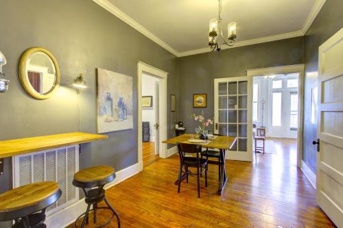 a living room with a table and chairs in it at Elegant Colonial with Lovely Details and Character in Memphis