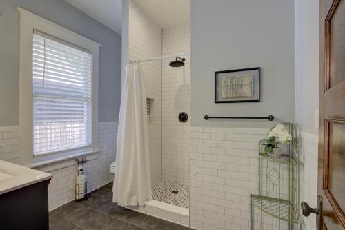 a white bathroom with a shower and a toilet at Classic Woodwork and Details in 1912 Colonial in Memphis
