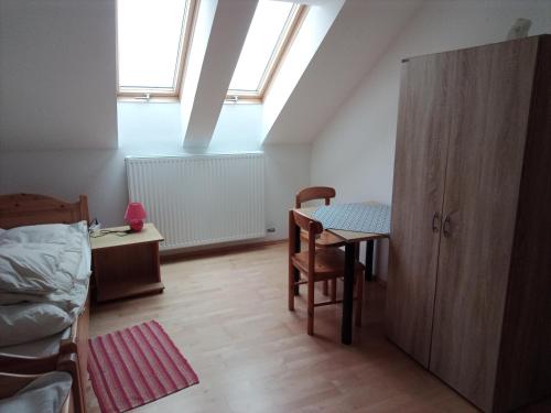 a bedroom with a table and a bed and a desk at Wohnen mit Panoramablick in Gramastetten