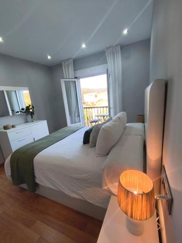 a bedroom with a large bed and a window at Curros in Ponte Do Porto