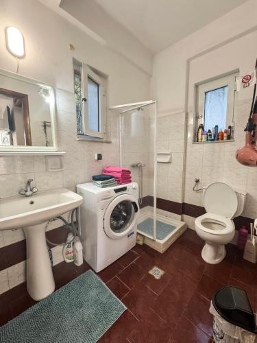 a bathroom with a washing machine and a sink at Olive Grove House in Kámpos