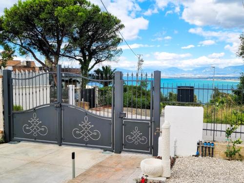 a black gate with a view of the ocean at Casa indipendente con giardino e vista mare - Casa Gennaro in Agropoli