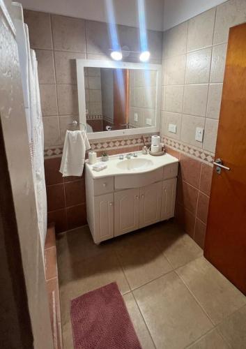 a bathroom with a sink and a mirror at Duplex Jauregui en Lujan in Luján