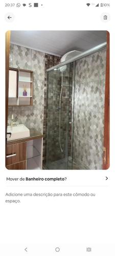 a bathroom with a shower and a sink at Condominio Central Charmoso in Uruguaiana