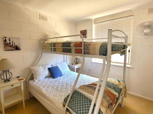 a bedroom with two bunk beds and a bed at Baccarat in Port Vincent