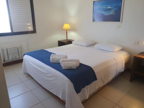 a bedroom with a large bed with towels on it at Beach Front 2 Bed Rooms - Balcony with Full Sea View - Praia do Pepê in Rio de Janeiro