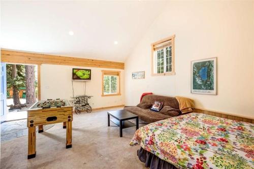 a bedroom with a bed and a couch and a table at Carnelian Bay Lake House in Carnelian Bay