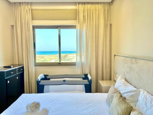 a bedroom with a bed with a view of the ocean at 360 Oceanfront & Sunset View Condo - Terrace & 2BR in Tangier