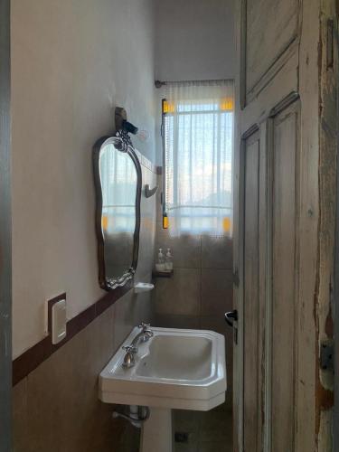a bathroom with a sink and a mirror on the wall at Casas de Época - Arrebol in Charbonier