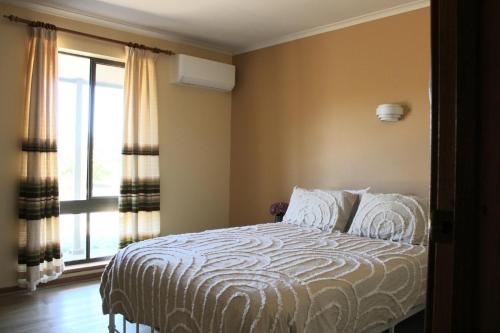 a bedroom with a bed and a large window at Willunga Farm Retreat in Willunga