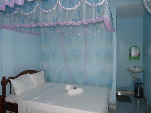 a bedroom with a bed with two towels on it at Cham Island Smiles Homestay in Tân Hiệp
