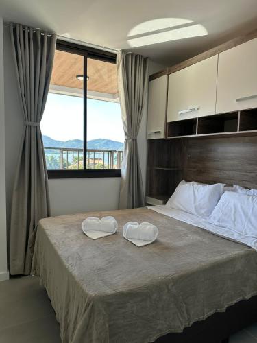 a bedroom with a bed with two hearts on it at Piratininga a Beira Mar - Niterói in Niterói