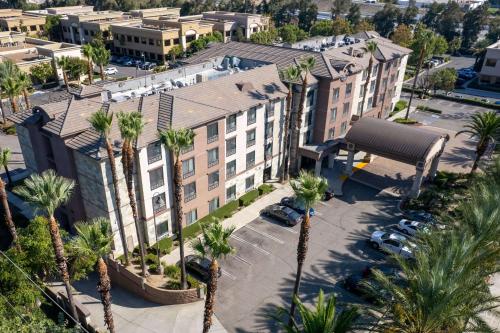 an aerial view of a building with palm trees at Country Inn & Suites by Radisson, Ontario at Ontario Mills, CA in Ontario
