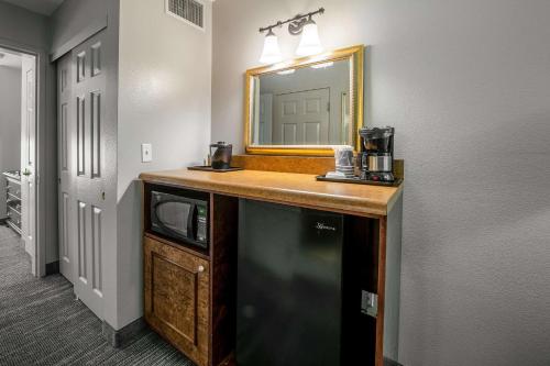 a bathroom with a sink and a mirror at Country Inn & Suites by Radisson, Ontario at Ontario Mills, CA in Ontario