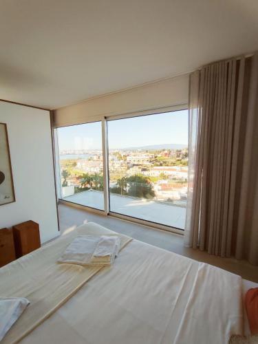 a bedroom with a bed and a large window at Deluxe 2 Terraces River&Marina View Flat in Ferragudo