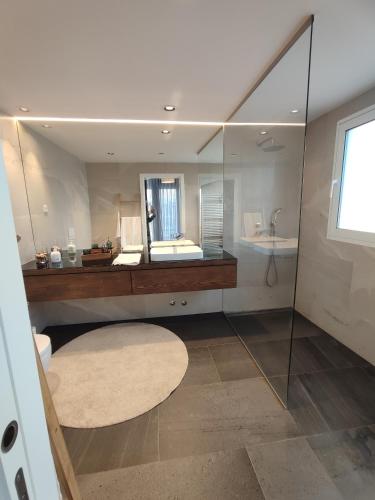 a bathroom with a large mirror and a sink at Deluxe 2 Terraces River&Marina View Flat in Ferragudo