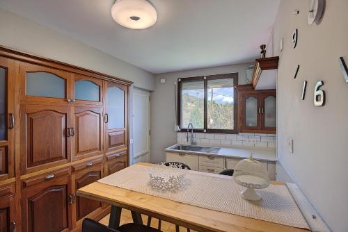a kitchen with wooden cabinets and a wooden table at VV La Karajita in Mazo